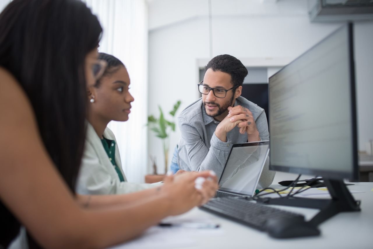 Diverse team engaging in collaborative work in a contemporary office environment.